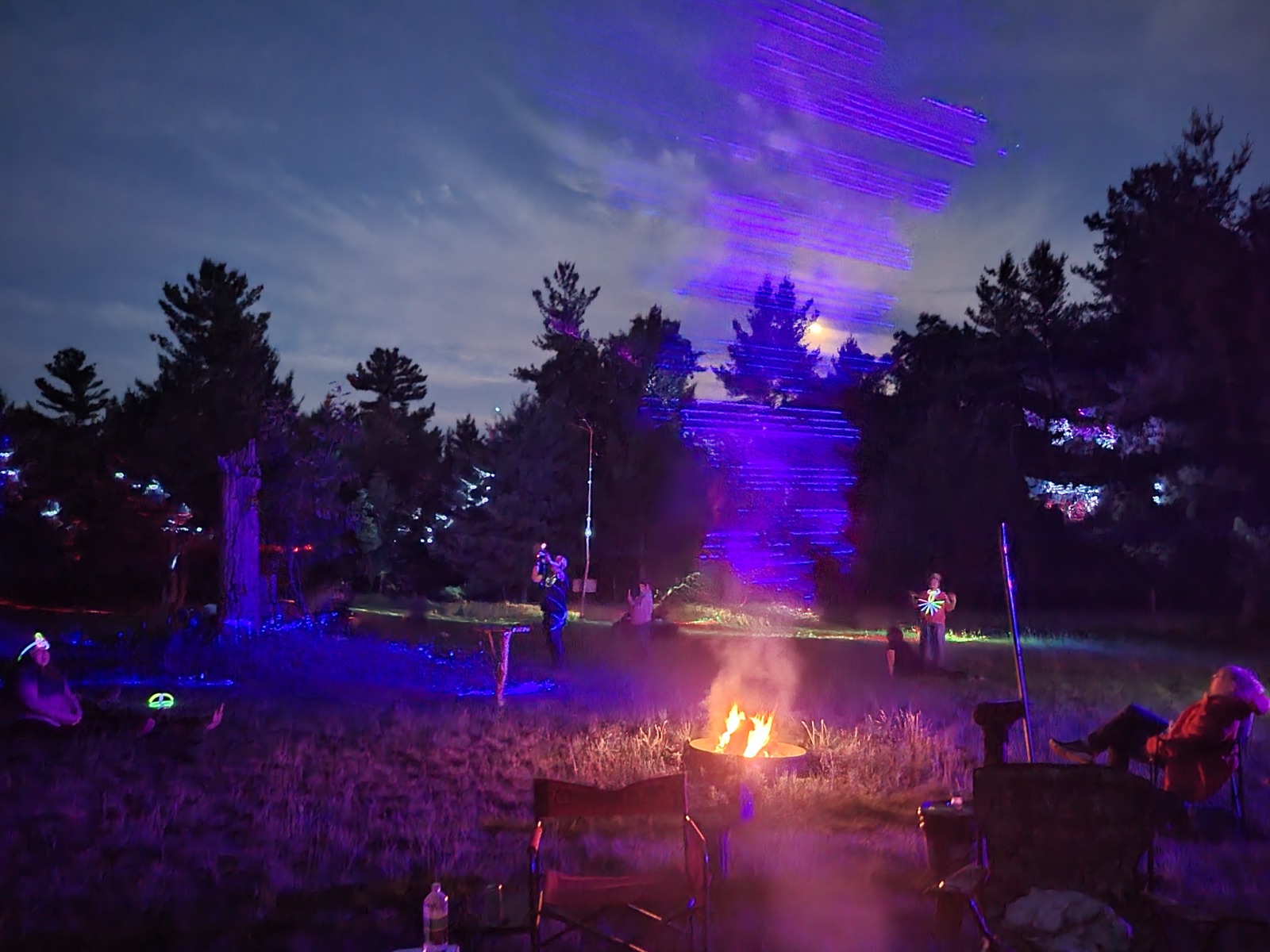 Purple light patterns over the field during the evening gathering